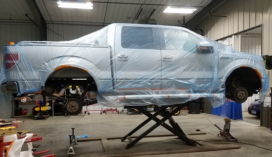 applying chip guard to truck body | Bailey’s Auto Body